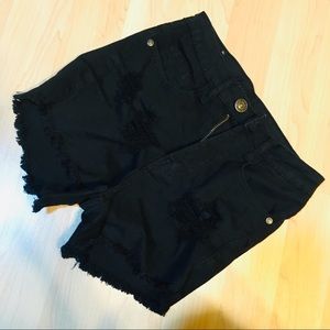 Distressed black denim cutoffs